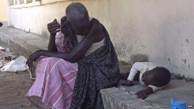 A South Sudanese woman with a child in Bor