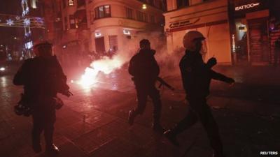 Turkish riot police chase demonstrators during an anti-government protest in Istanbul