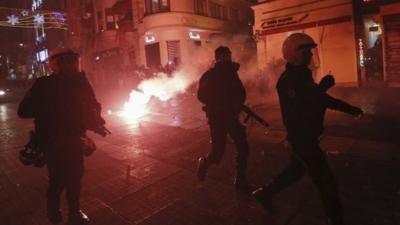 Turkish riot police chase demonstrators during an anti-government protest in Istanbul