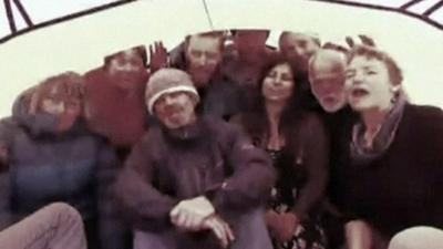 Scientists and tourists trapped aboard the MV Akademik Shokalskiy ship sing a song