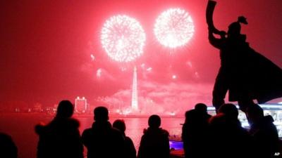 Fireworks explode over Juche Tower and the Taedong River in Pyongyang, North Korea