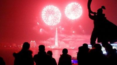 Fireworks explode over Juche Tower and the Taedong River in Pyongyang, North Korea