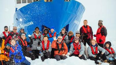 Passengers beside the MV Akademik Shokalskiy, which is currently trapped in ice in the Antarctic