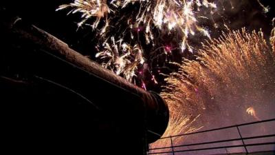 Fireworks seen near a cannon at Edinburgh Castle