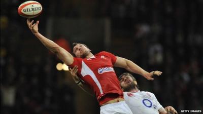 Sam Warburton reaches for the ball under pressure from England lock Geoff Parling