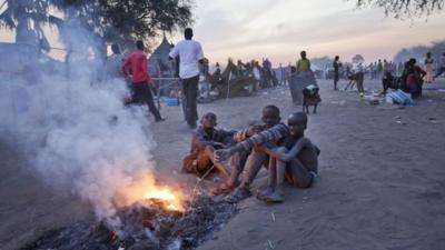 Boys around a fire in the Awerial refugee camp