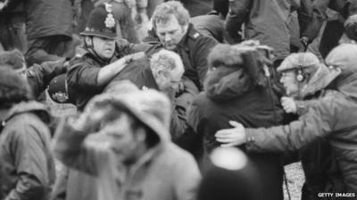 A camera crew films a scuffle between police and miners at a demonstration at Orgreave Colliery, South Yorkshire, during the miner's strike, 1984