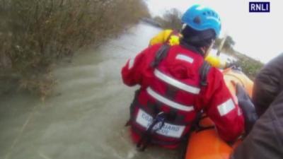 Coastguard stands in waist-deep water