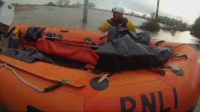 Coastguard stands in waist-deep water