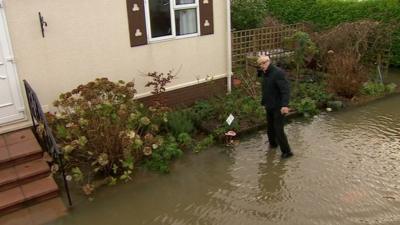 Patrick Pope outside his flooded home