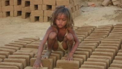 Child sat on bricks