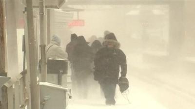 Passengers on snowy platform