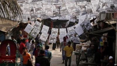 People walking under election posters