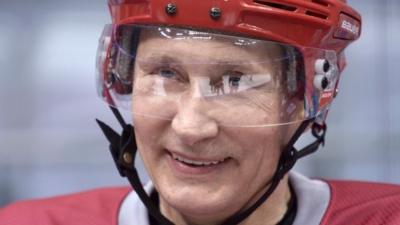 Vladimir Putin wearing an ice hockey helmet