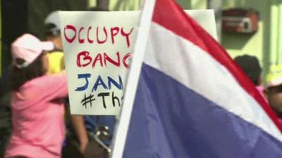 Placard and flag at anti-government protest in Bangkok