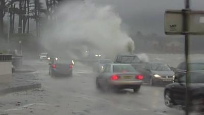 Waves crash over a road in Northern Ireland