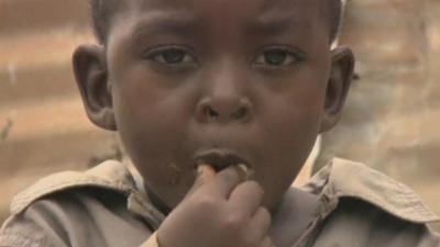 Boy eating a grasshopper