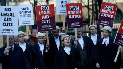 Legal professionals protest against cuts to the legal aid budget outside Southwark Crown Court in London