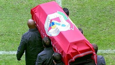 Eusebio da Silva Ferreira's coffin being carried onto Lisbon football stadium