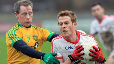 Donegal defender Anthony Thompson challenges Tyrone's Niall McKenna