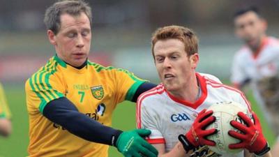 Donegal defender Anthony Thompson challenges Tyrone's Niall McKenna