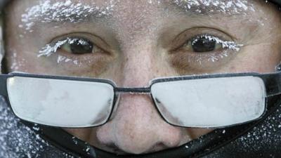 A man on his way to work feels the effects of the icy cold weather in Janesville, Wisconsin