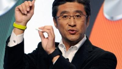 Kunimasa Suzuki displays a Sony SmartBand and Core