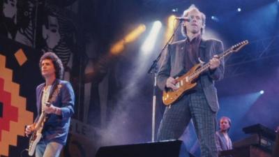 John Illsley (left) performing with Dire Straits