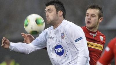 Coleraine's Eoin Bradley shields the ball from Cliftonville's Jamie McGovern