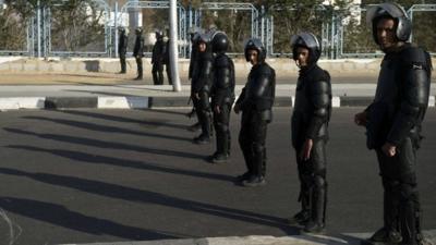 Riot police line up outside the police academy in Cairo