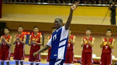 Dennis Rodman waves to the crowd