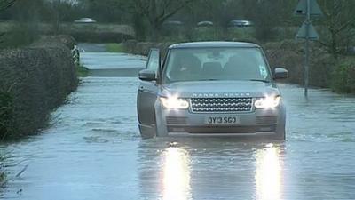 A car drives through flood water