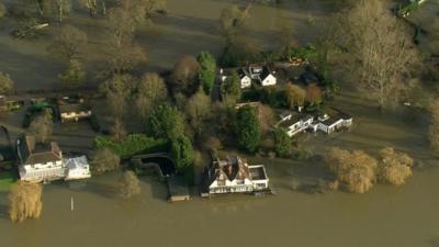 Houses surrounded by flood water in the Thames Valley region