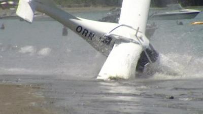 A plane crashing into the sea at Martins Bay, New Zealand