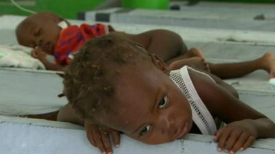 Children with cholera in hospital beds