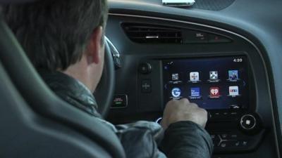 Man looking at car display panel