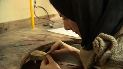 A girl makes jewellery in Kabul's old city
