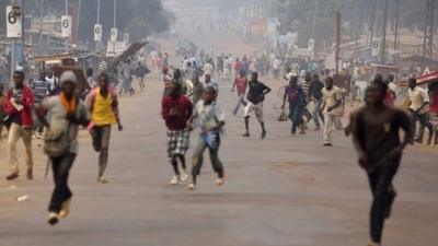 Looters run for cover as they hear rifle shots