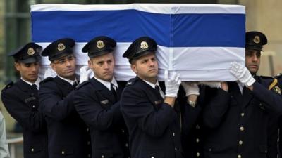 Members of the Knesset guard carry the coffin of late Israeli Prime Minister Ariel Sharon