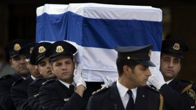 Members of the Knesset guard carry the coffin of Ariel Sharon