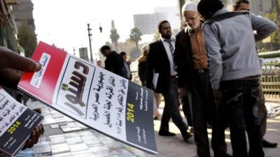 An Egyptian vender sells copies of the last constitution in Cairo, Egypt, 28 December 2013