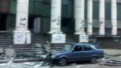 Debris and car with blown-out windows in Cairo