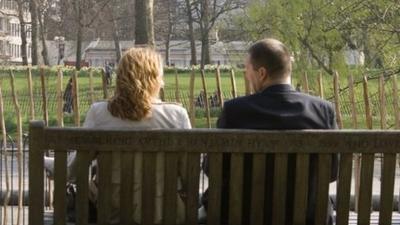 A couple sat on a park bench