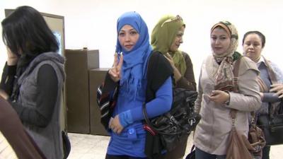 Women queue to vote inside a polling station