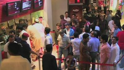 People queuing up to buy cinema tickets at a multiplex in Pakistan