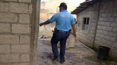 Police at the house in Ibabao, Philippines