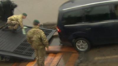 Royal Marines removing the cars