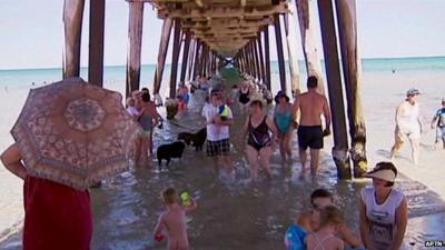 People under jetty on beach in Adelaide