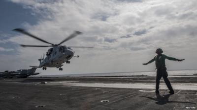 Helicopter lifts off from lifts off from the aircraft carrier USS George Washington
