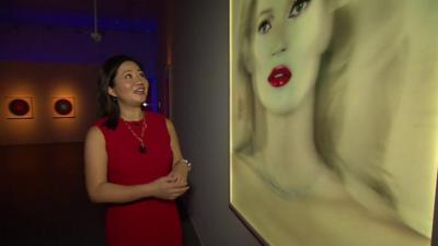 Linda Yueh and painting of Kate Moss